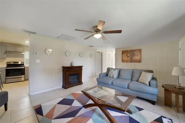 a living room with furniture a fireplace and a flat screen tv