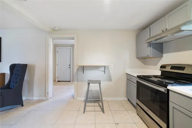 a kitchen with a stove a sink and a microwave