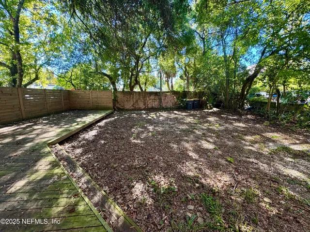 a backyard of a house with lots of trees