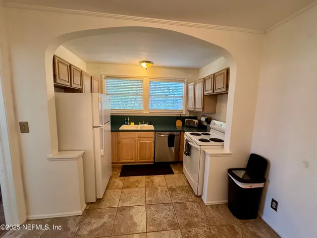 a kitchen with a sink a stove and refrigerator