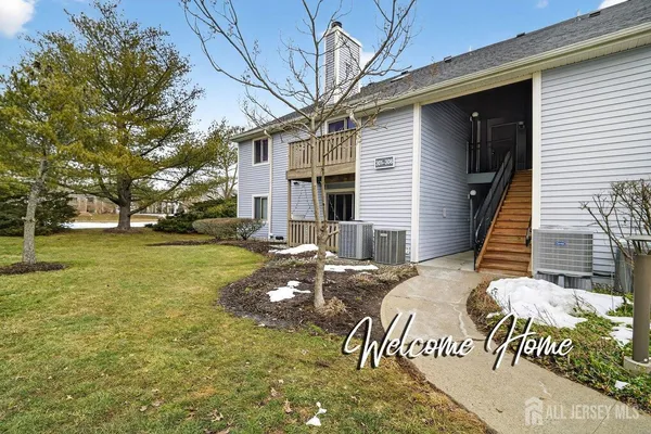 a front view of house with a garden