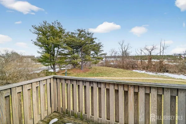a view of a balcony with wooden fence