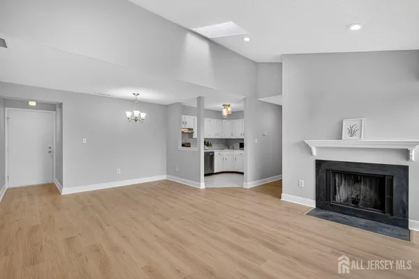 a view of a kitchen and an empty room
