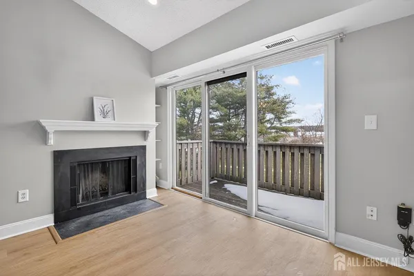 a living room with a fireplace and a floor to ceiling window