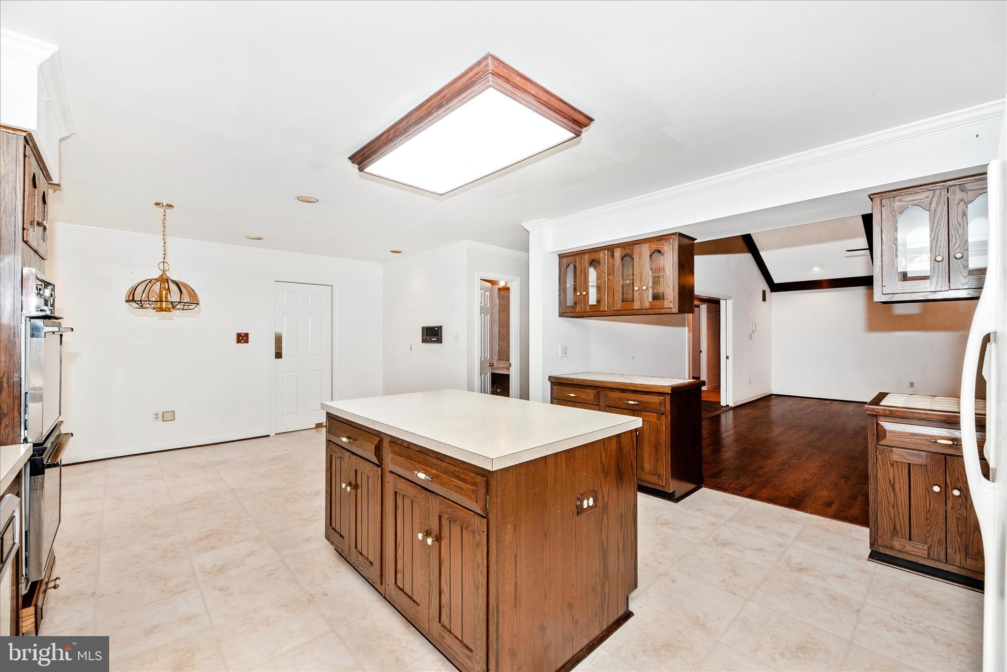 2221 Gold Mine Road Brookeville, MD 20833 - Photo 21 of 60 a living room with stainless steel appliances kitchen island a table chairs refrigerator and sink