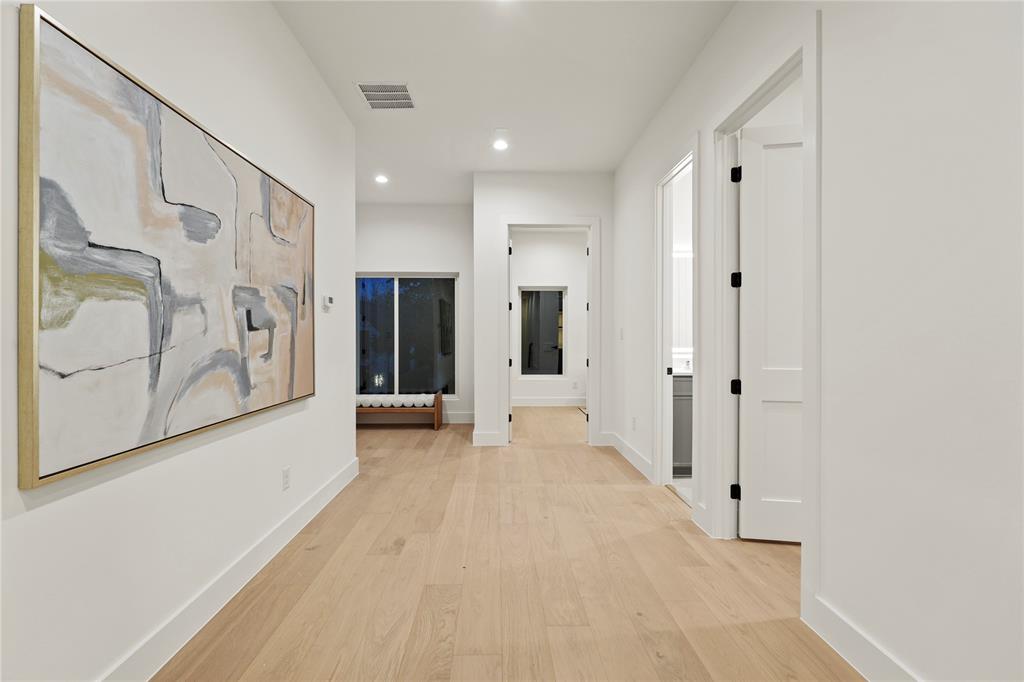 8623 San Fernando Way Dallas, TX 75218 - Photo 11 of 40 a view of a hallway with paintings on the wall