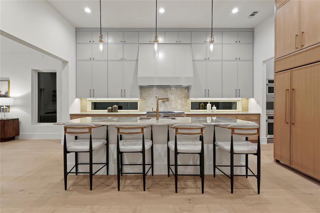 8623 San Fernando Way Dallas, TX 75218 - Photo 16 of 40 a kitchen with cabinets and chairs