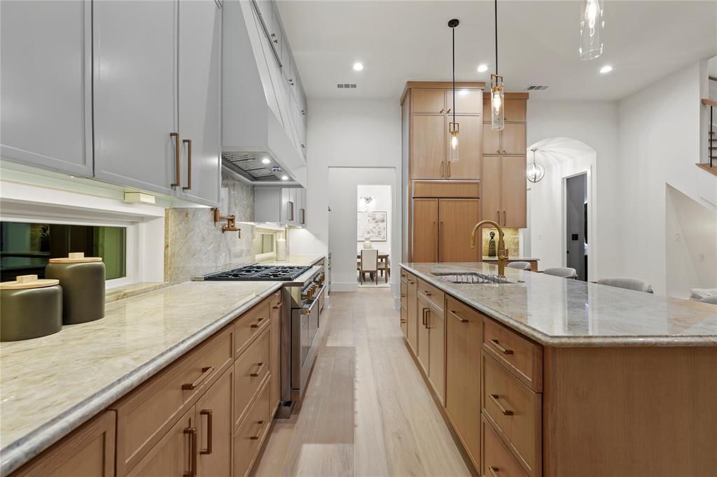 8623 San Fernando Way Dallas, TX 75218 - Photo 18 of 40 a kitchen with stainless steel appliances granite countertop a sink a stove and a refrigerator