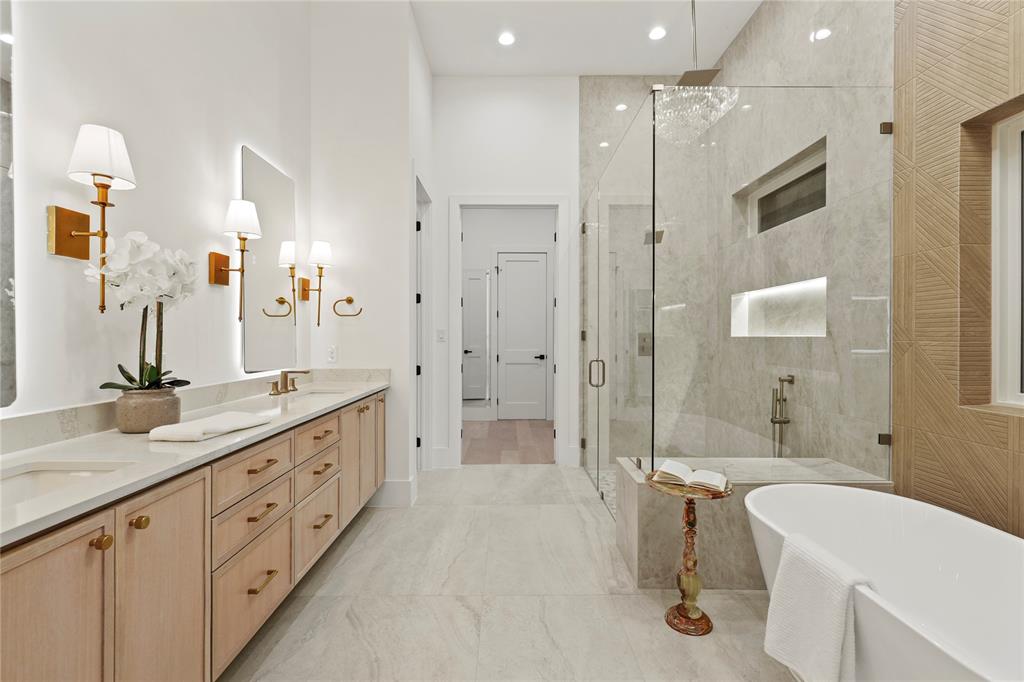 8623 San Fernando Way Dallas, TX 75218 - Photo 23 of 40 a spacious bathroom with a double vanity sink toilet mirror and shower