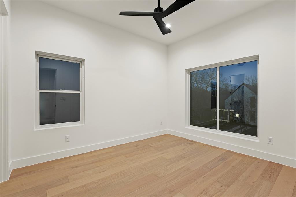8623 San Fernando Way Dallas, TX 75218 - Photo 31 of 40 a view of an empty room with wooden floor and a window
