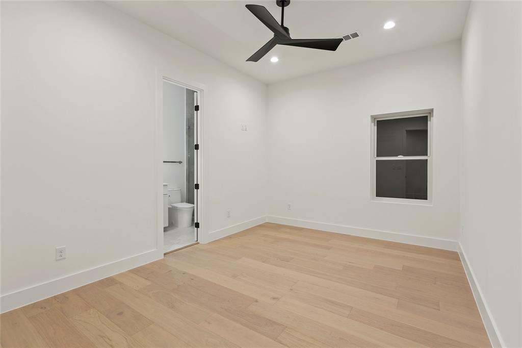 8623 San Fernando Way Dallas, TX 75218 - Photo 33 of 40 an empty room with an entryway and wooden floor