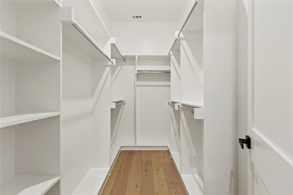 8623 San Fernando Way Dallas, TX 75218 - Photo 10 of 40 a view of walk in closet with empty racks