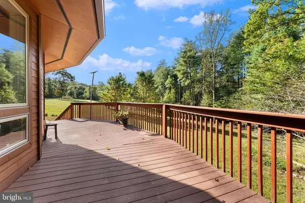 a view of balcony with wooden floor and fence