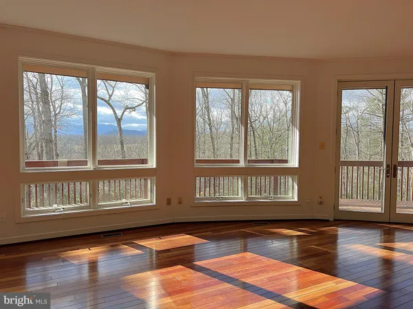 a view of kitchen with furniture and wooden floor