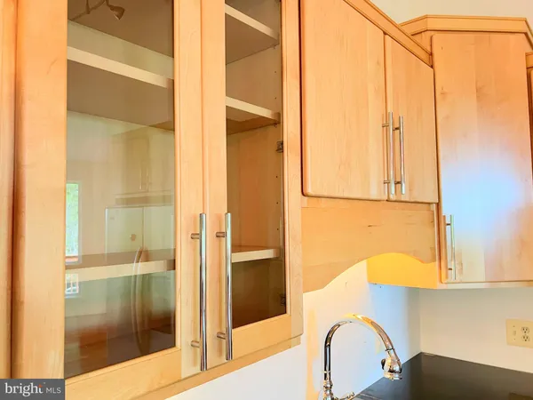 a view of an empty room with wooden floor and windows