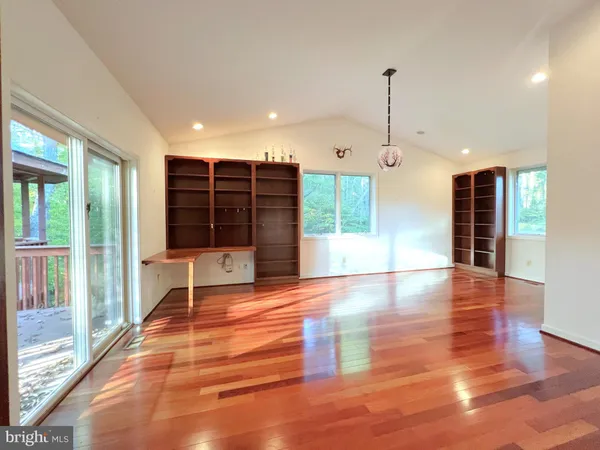 a view of room with hardwood floor and window