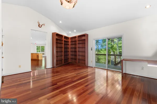 a spacious bathroom with a granite countertop sink and a mirror