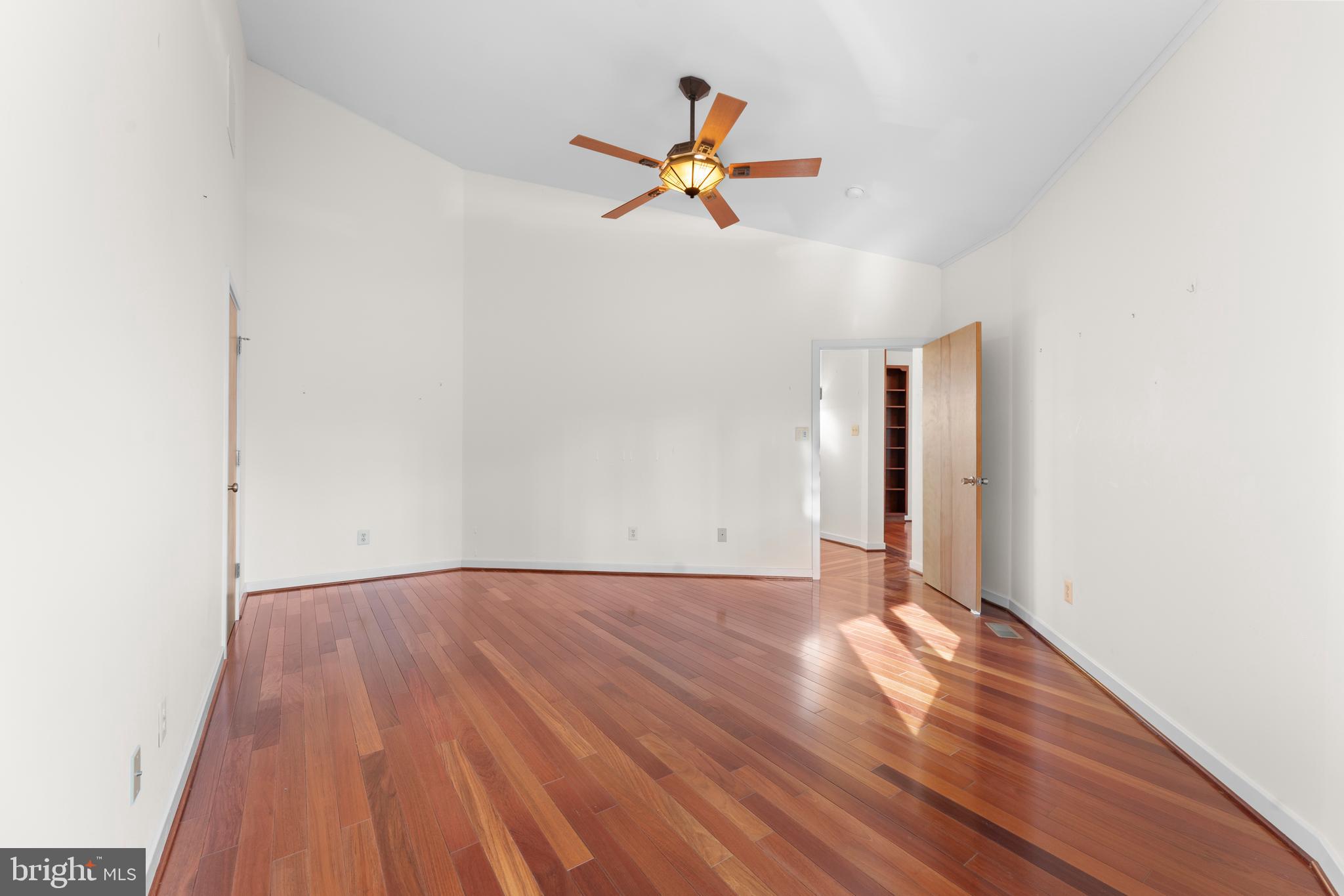 243 Aaron Mountain Road Castleton, VA 22716 - Photo 27 of 58 a view of an empty room with wooden floor and a ceiling fan