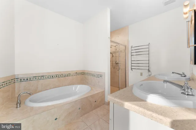 a view of walk in closet with wooden floor
