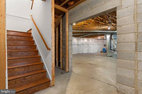 a view of a house with a yard and large tree