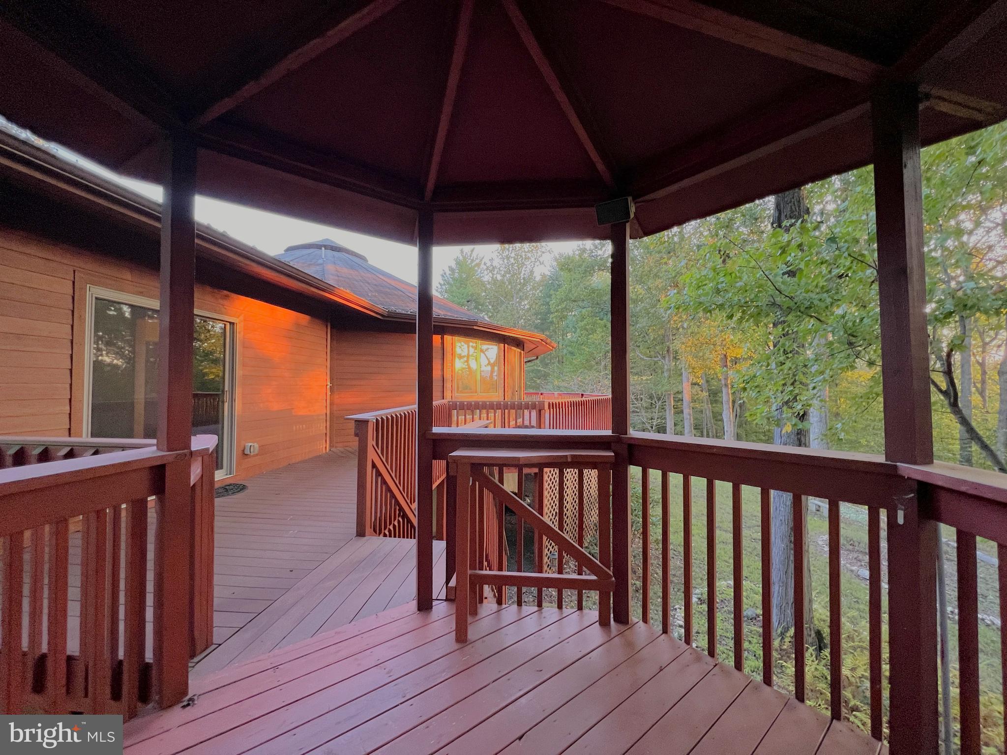 243 Aaron Mountain Road Castleton, VA 22716 - Photo 53 of 53 Setting sun streams through the forest onto deck