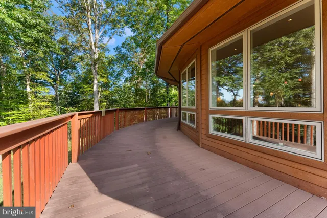 a view of balcony with wooden floor and fence
