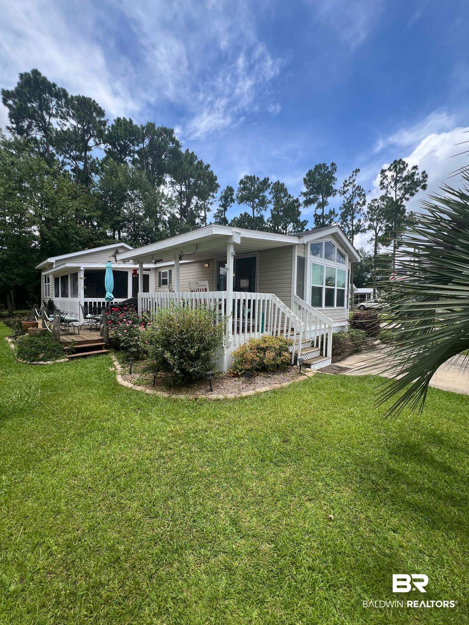 168 Defuniak Loop Lillian, AL 36549 - Photo 2 of 28 Back of house featuring a yard