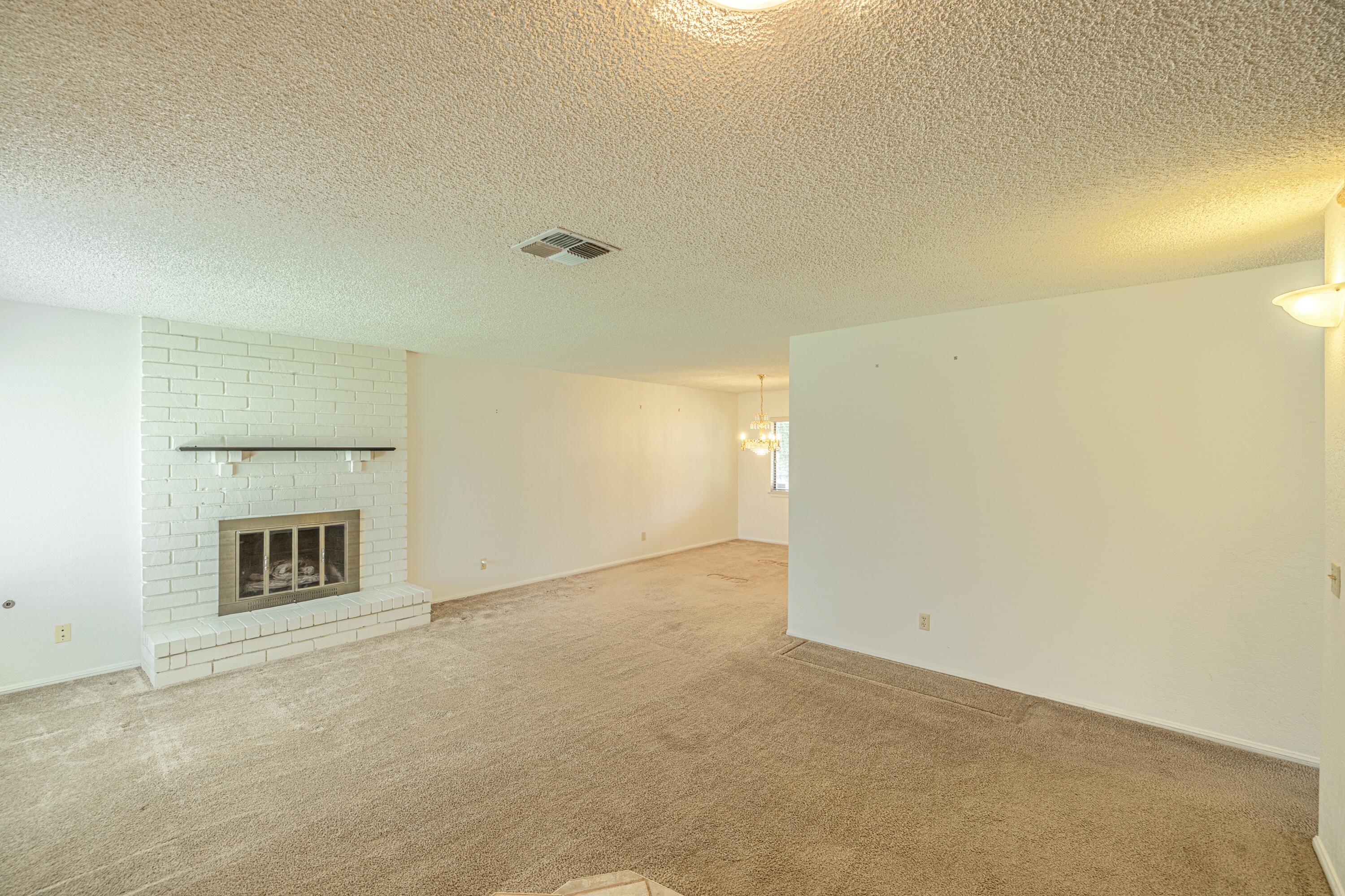 431 Fantasy Street Palmdale, CA 93551 - Photo 1 of 24 a view of an empty room with a fireplace and a window