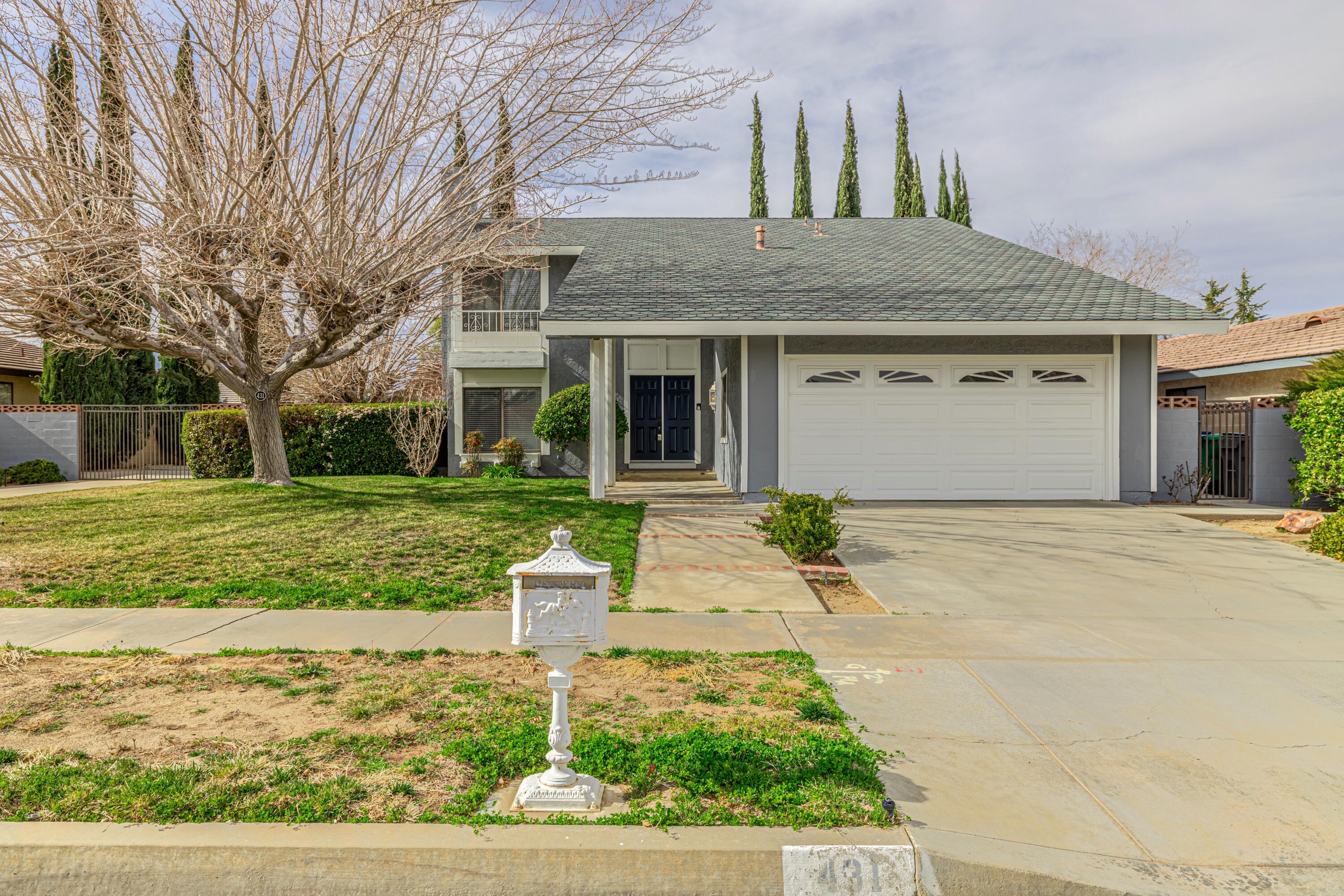 431 Fantasy Street Palmdale, CA 93551 - Photo 11 of 24 a front view of a house with garden