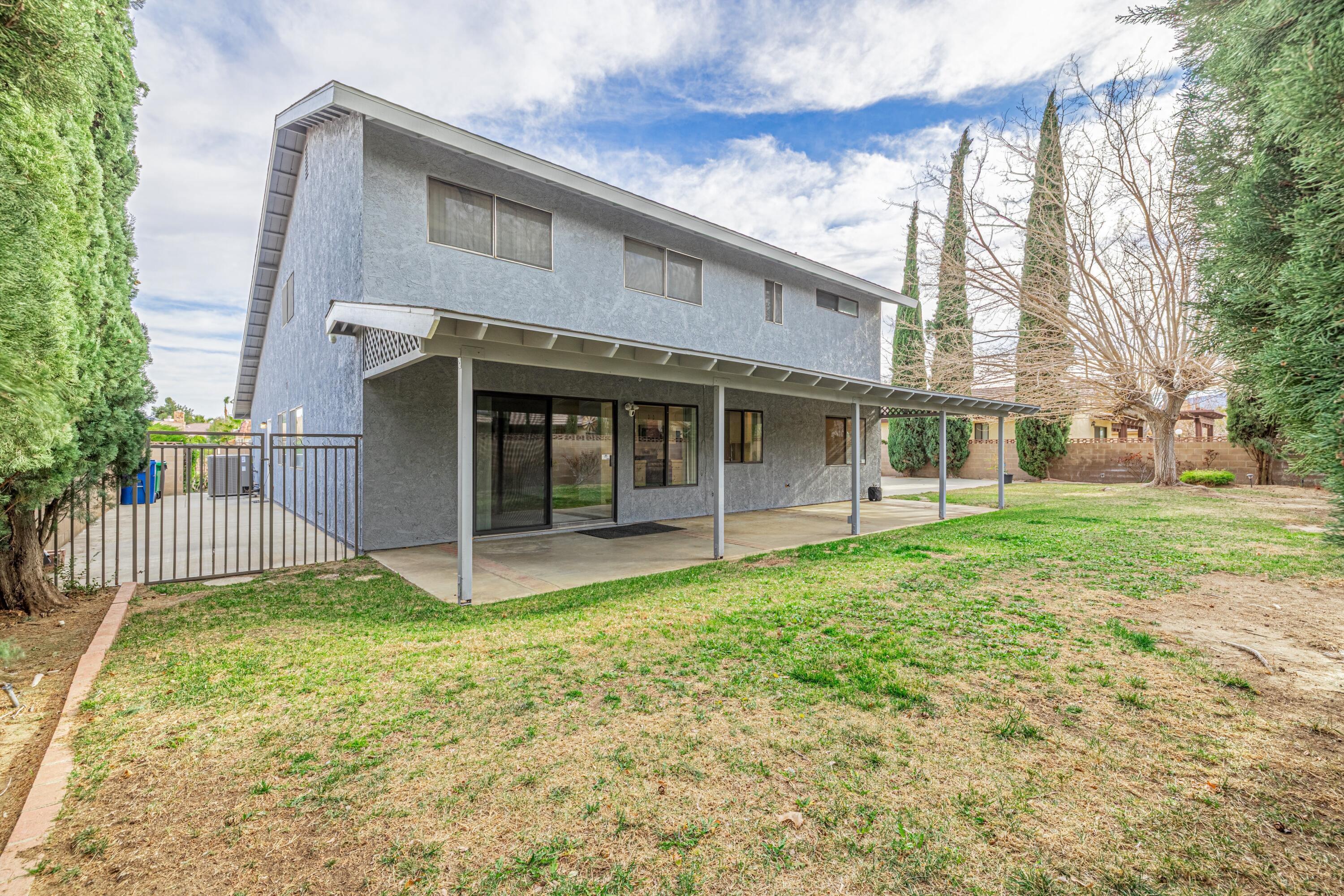 431 Fantasy Street Palmdale, CA 93551 - Photo 17 of 24 a view of a house with a yard and a large tree