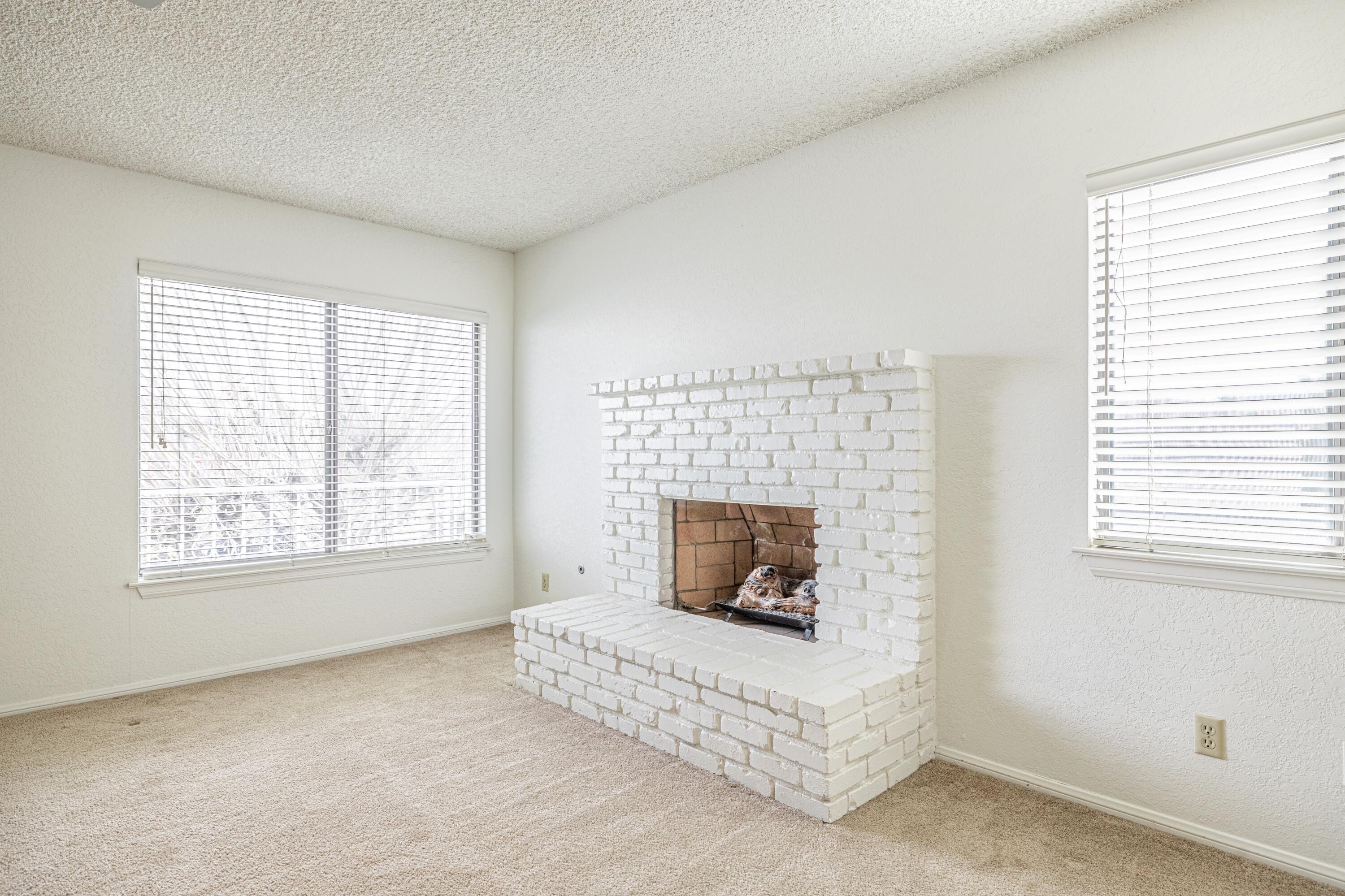 431 Fantasy Street Palmdale, CA 93551 - Photo 6 of 24 a living room with furniture a flat screen tv and a fireplace