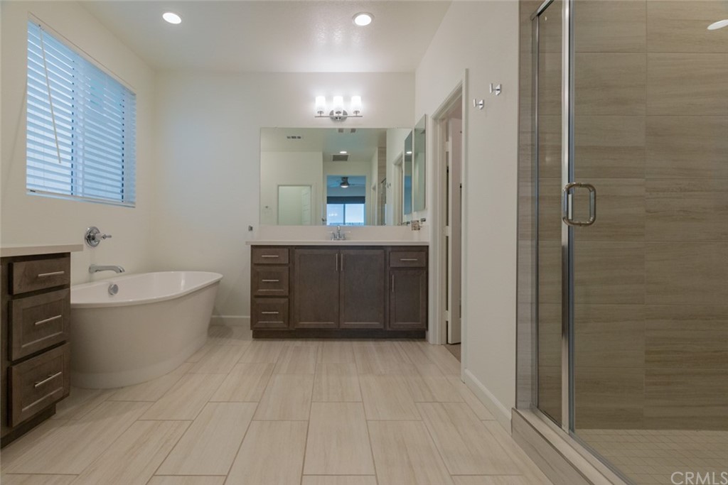 32151 Everview Temecula, CA 92591 - Photo 6 of 29 a bathroom with a bathtub shower sink vanity and toilet
