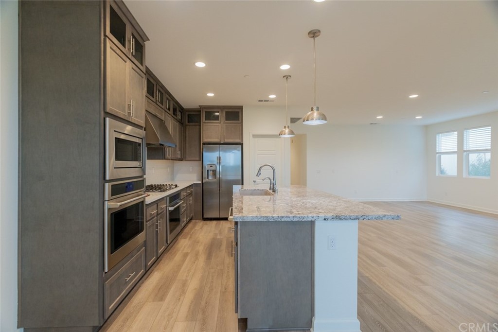 32151 Everview Temecula, CA 92591 - Photo 8 of 29 a large kitchen with stainless steel appliances granite countertop a large counter top a stove and a sink