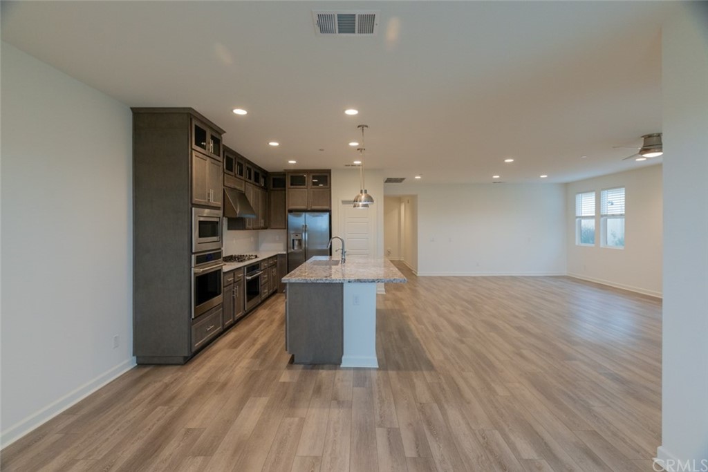 32151 Everview Temecula, CA 92591 - Photo 9 of 29 a view of kitchen with cabinets and wooden floor