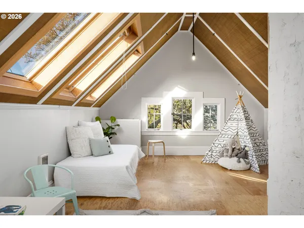 a bedroom with furniture and a large window