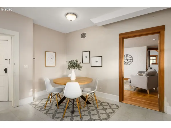 a dining room with furniture and wooden floor