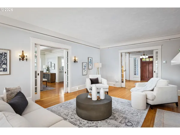 a living room with furniture and a wooden floor