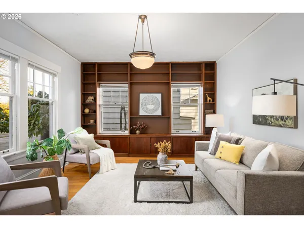 a living room with furniture and wooden floor