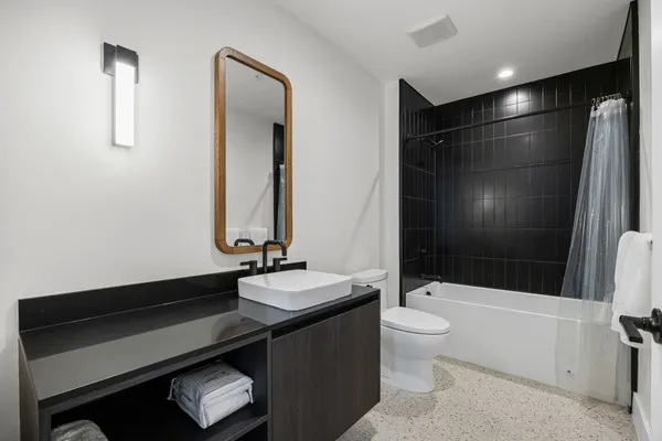 a bathroom with a double vanity sink toilet and shower