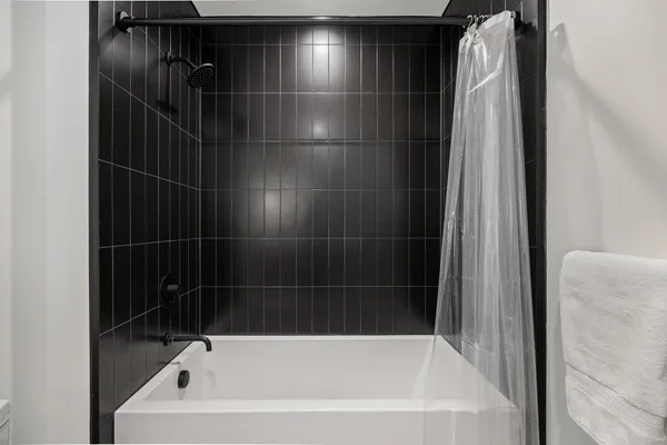 a bathroom with a shower and a bathtub