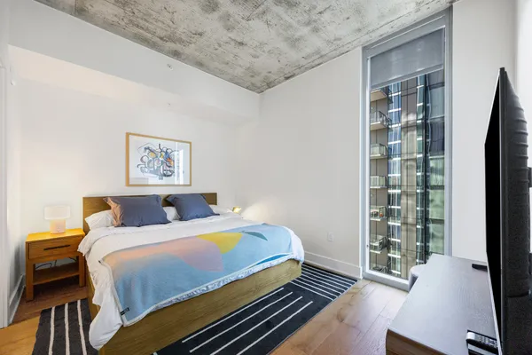 a bedroom with a bed and a window