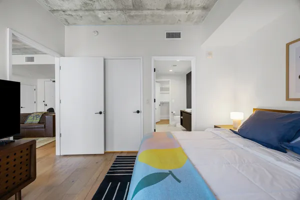 a bedroom with a bed and a flat screen tv