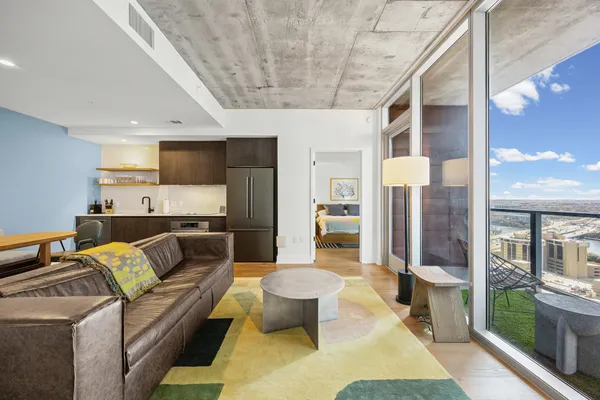 a living room with furniture and a chandelier