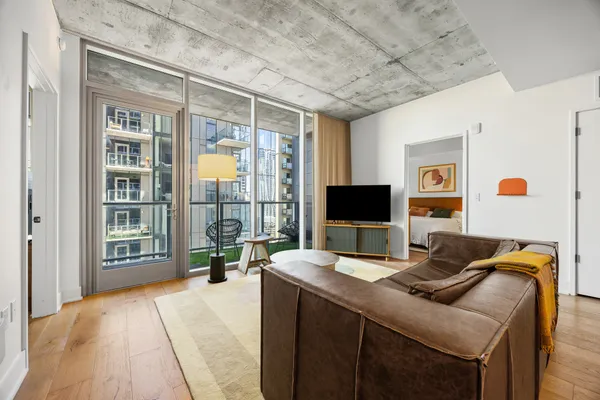 a bedroom with a bed and glass door