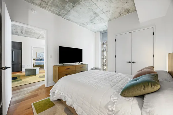 a bedroom with a bed and a flat screen tv