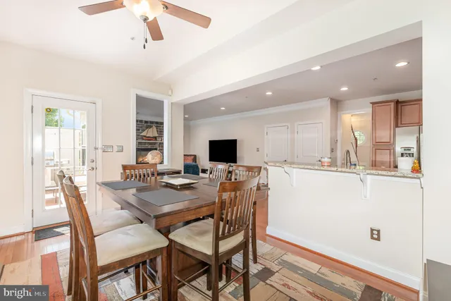 a dining room with furniture window and wooden floor
