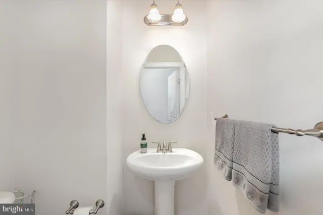 a bathroom with a sink a mirror and vanity