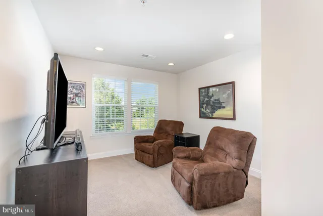 a living room with furniture window and a flat screen tv