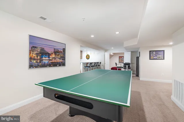 a room with pool table and windows