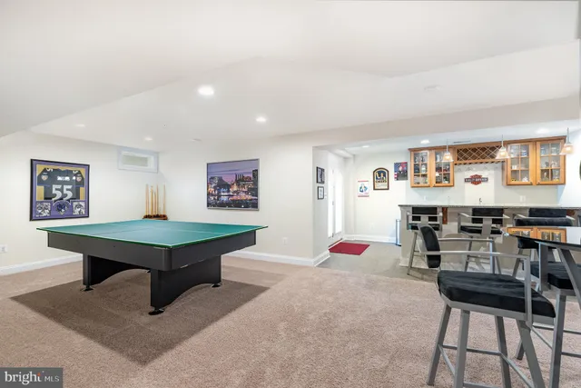 a room with furniture pool table and windows
